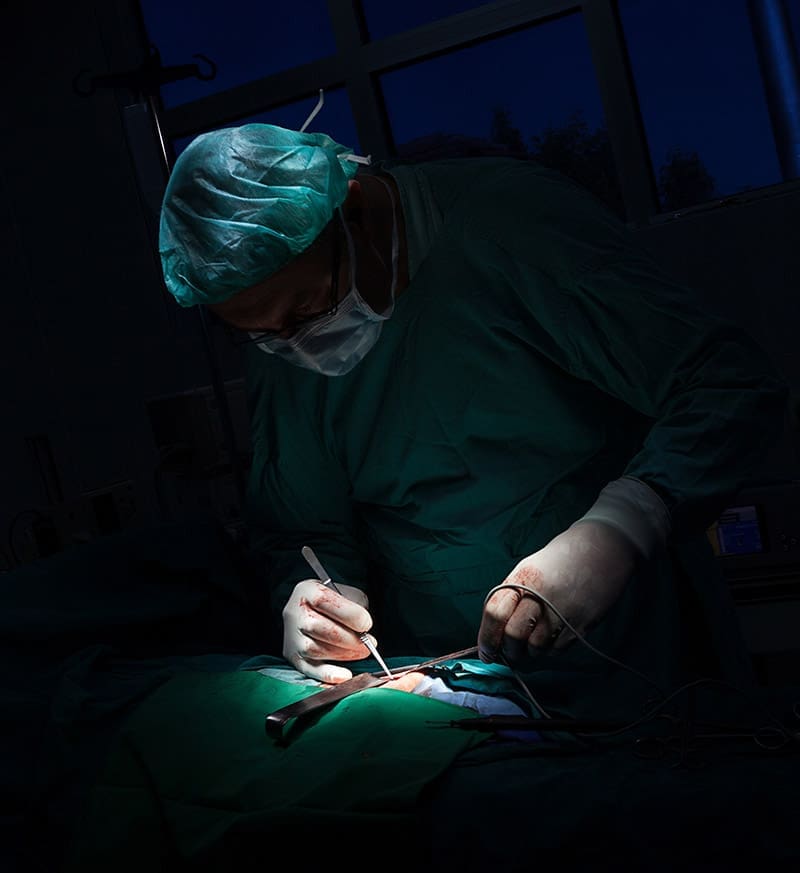 a person in scrubs performing surgery